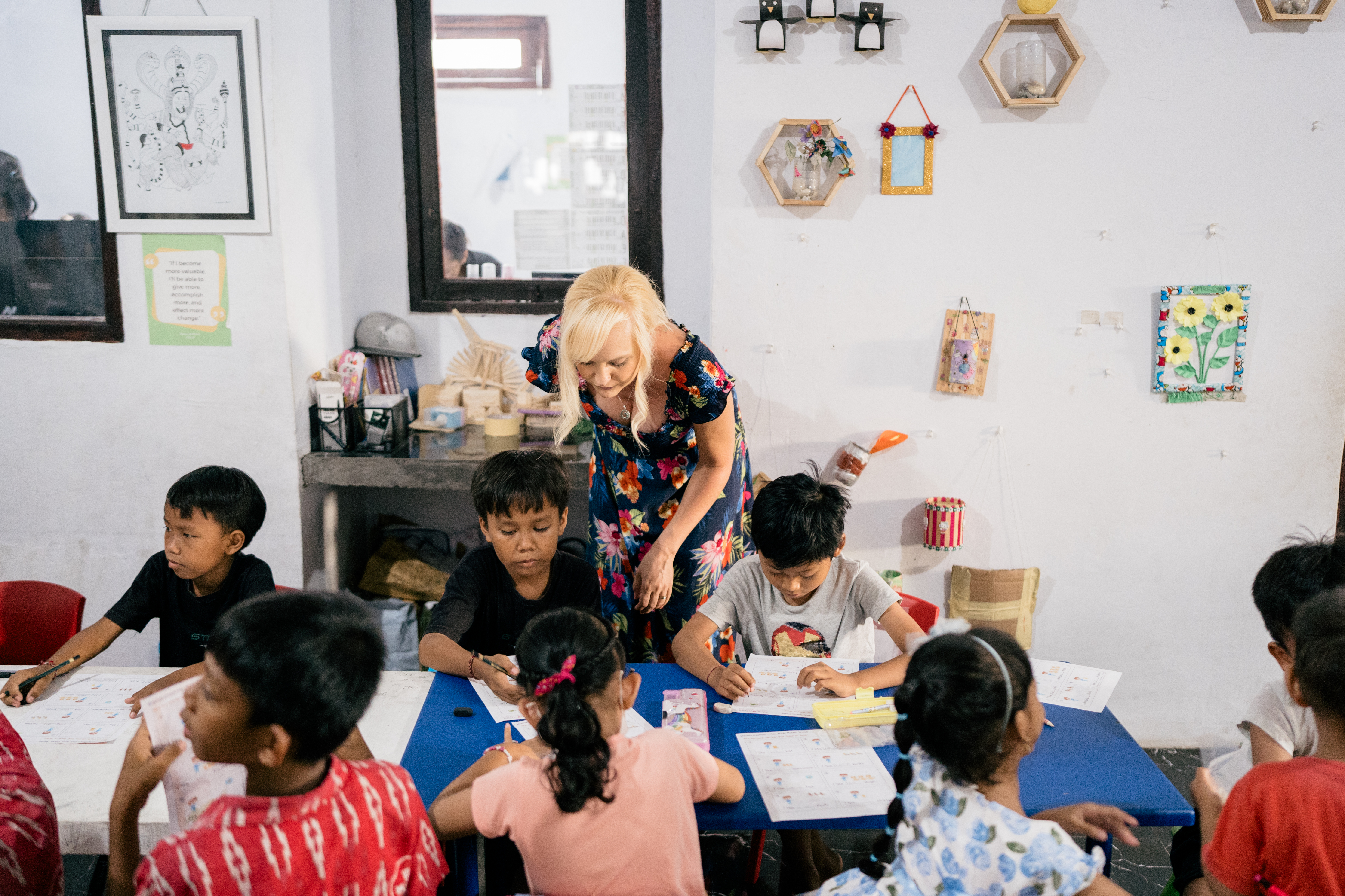 Volunteer teacher helping children with learning activities